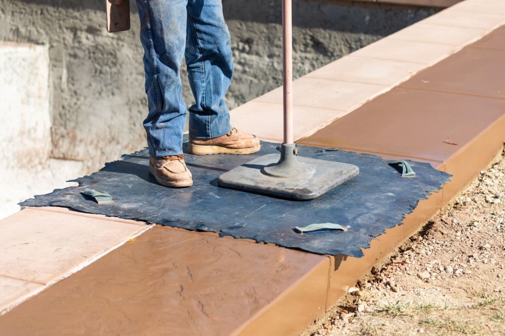 A man is preparing the floor for concrete installation.