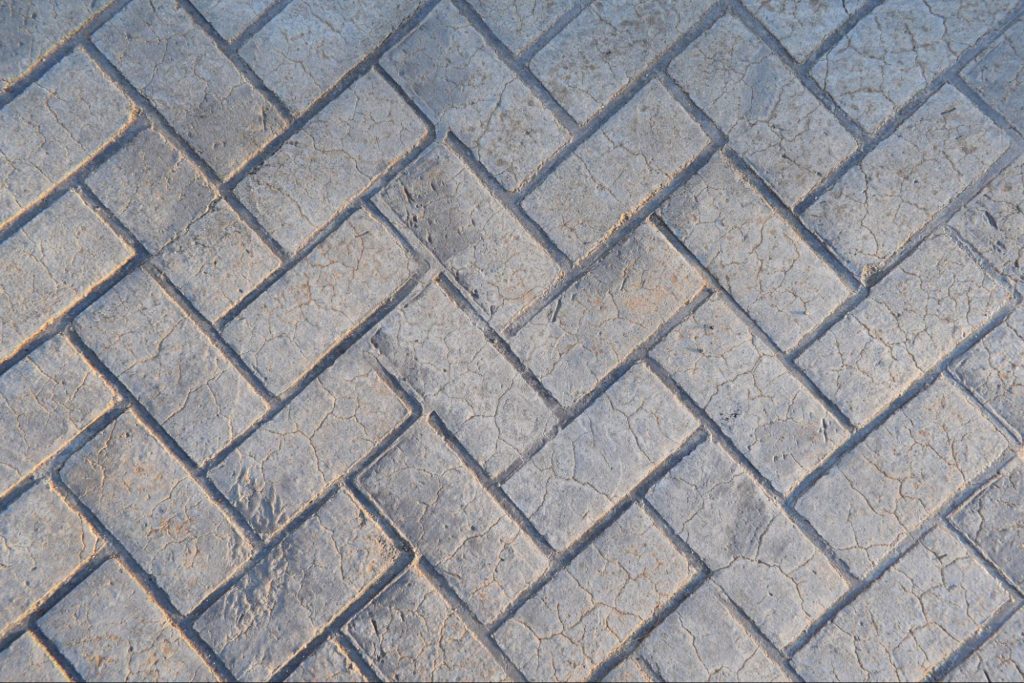 Close-up shot of a floor showcasing a stamped concrete texture's intricate patterns and details.