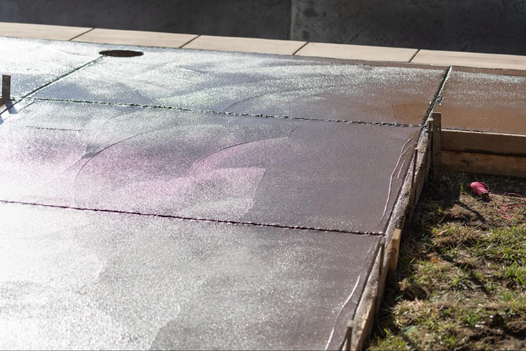 Freshly poured concrete in a wooden frame.